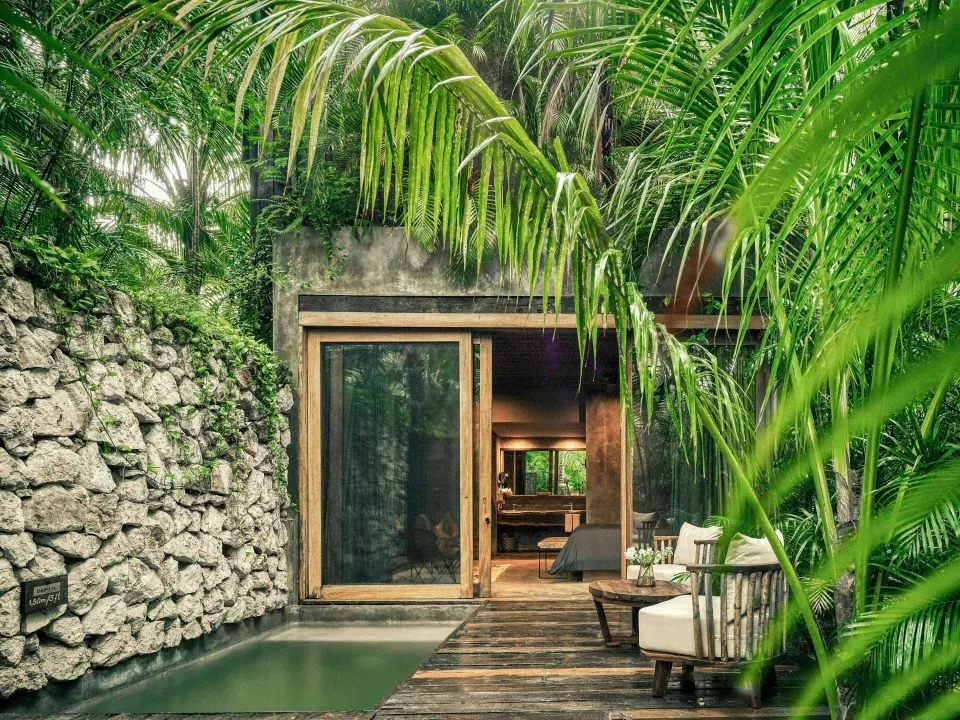 Exterior terrace of Signature Suite with private plunge pool and stone wall at BE Destination Tulum