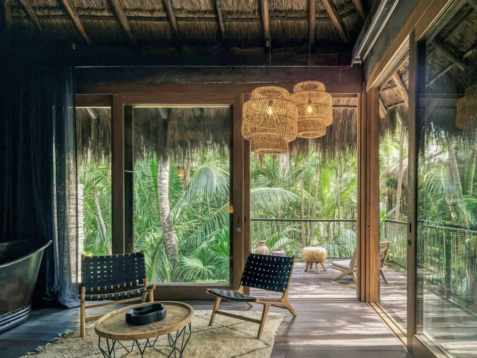 Palm Suite seating area and balcony with jungle view at BE Destination Tulum