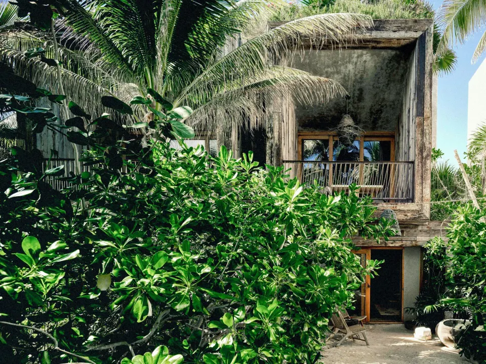 Exterior façade of Sea Suite with balcony and lush tropical foliage at BE Destination Tulum