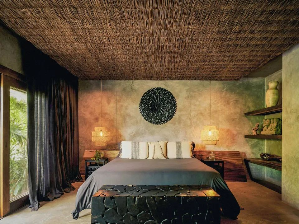 King bed in Sea Suite with textured ceiling and tropical window at BE Destination Tulum
