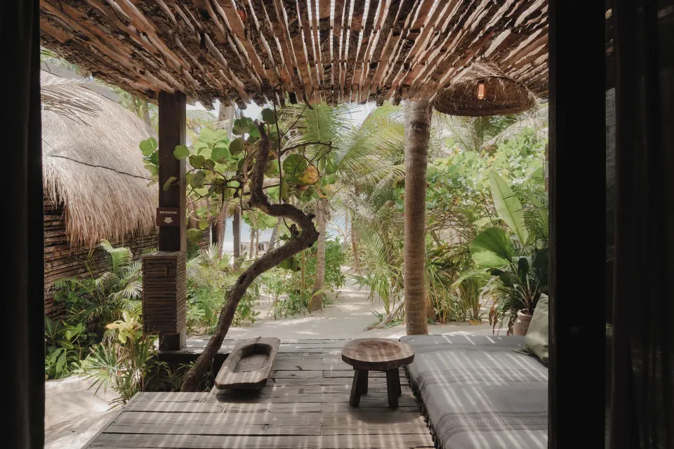 Patio view from Sea Suite looking toward tropical garden and beach path at BE Destination Tulum