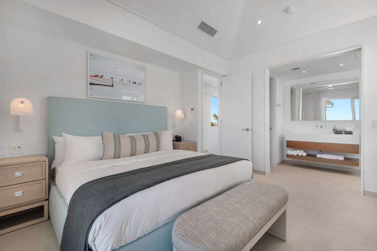 Bedroom with king bed and open bathroom vanity at Beach Enclave.