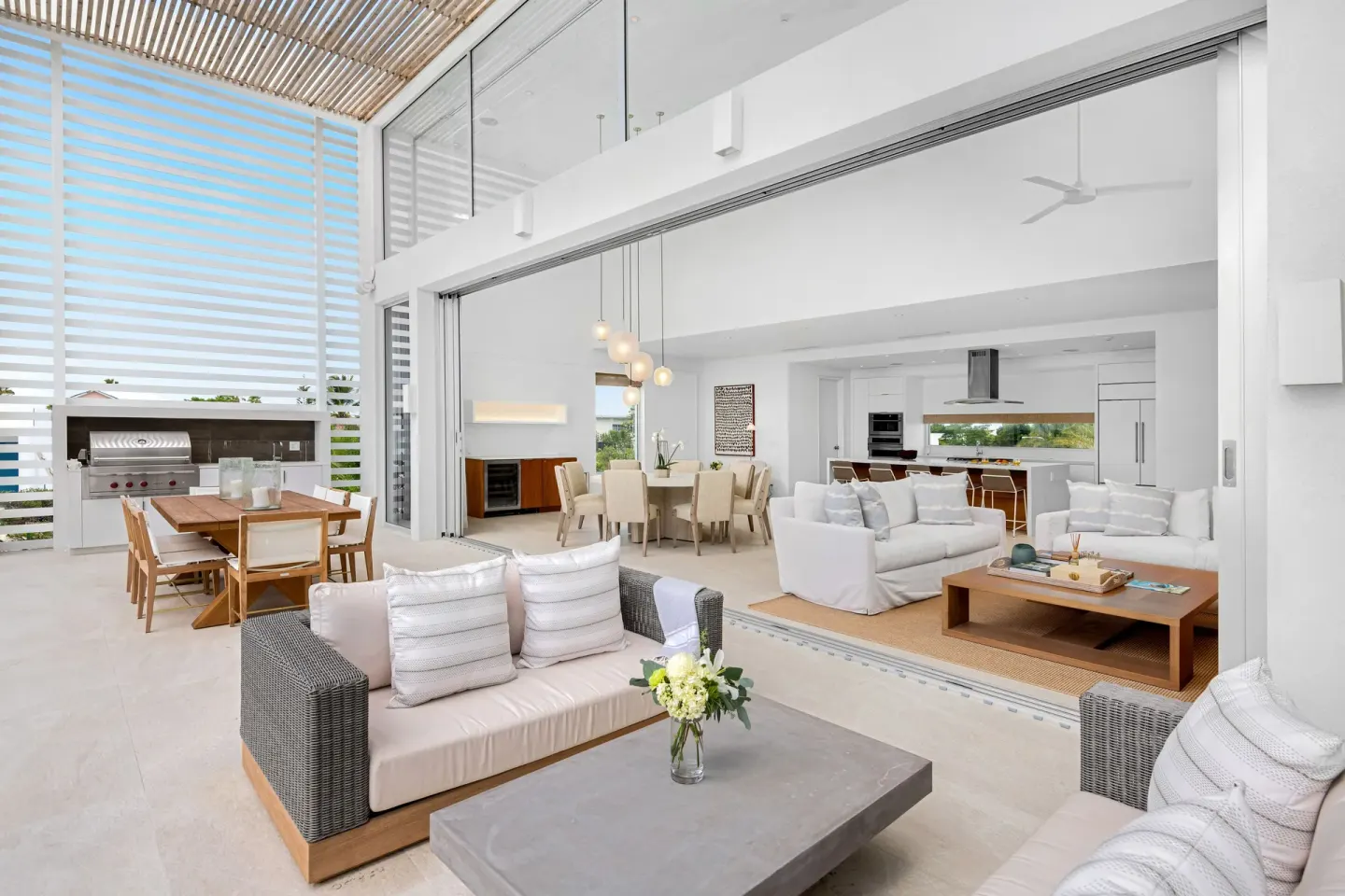 Covered patio and open living area with dining and kitchen at Beach Enclave.