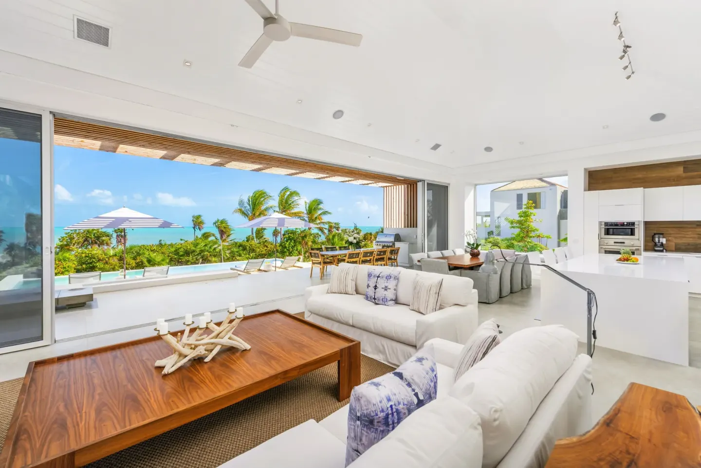 Open living room and kitchen with ocean terrace at Beach Enclave.