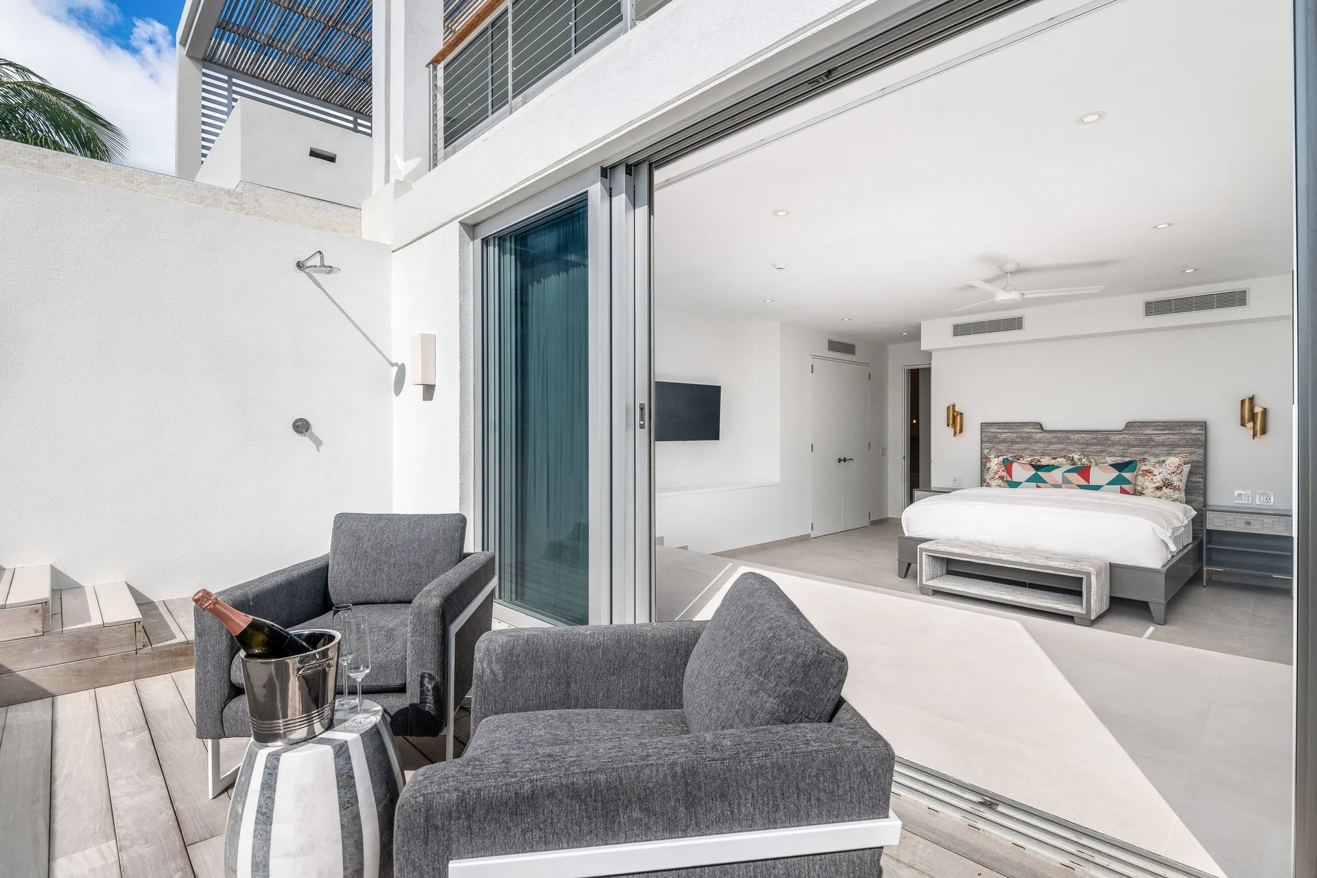 Private terrace with lounge chairs outside a king bedroom at Beach Enclave.