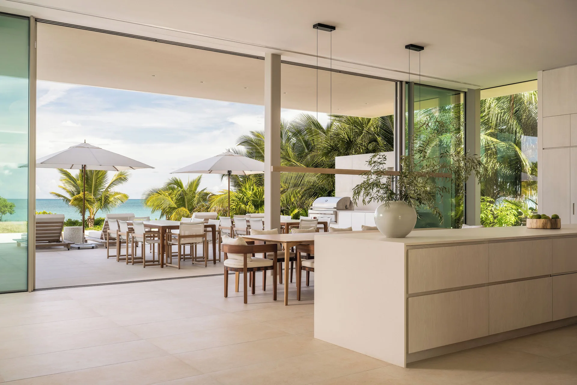 Indoor-outdoor dining area at North Shore Five-Bedroom Ocean View Villa at Beach Enclave with open-air design and ocean scenery in Turks and Caicos.