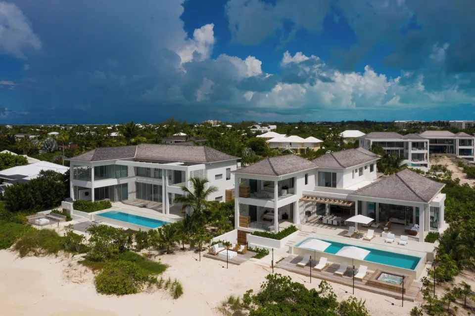 Aerial view of The Reserve at Grace Bay Villa beachfront buildings and pools at Beach Enclave.