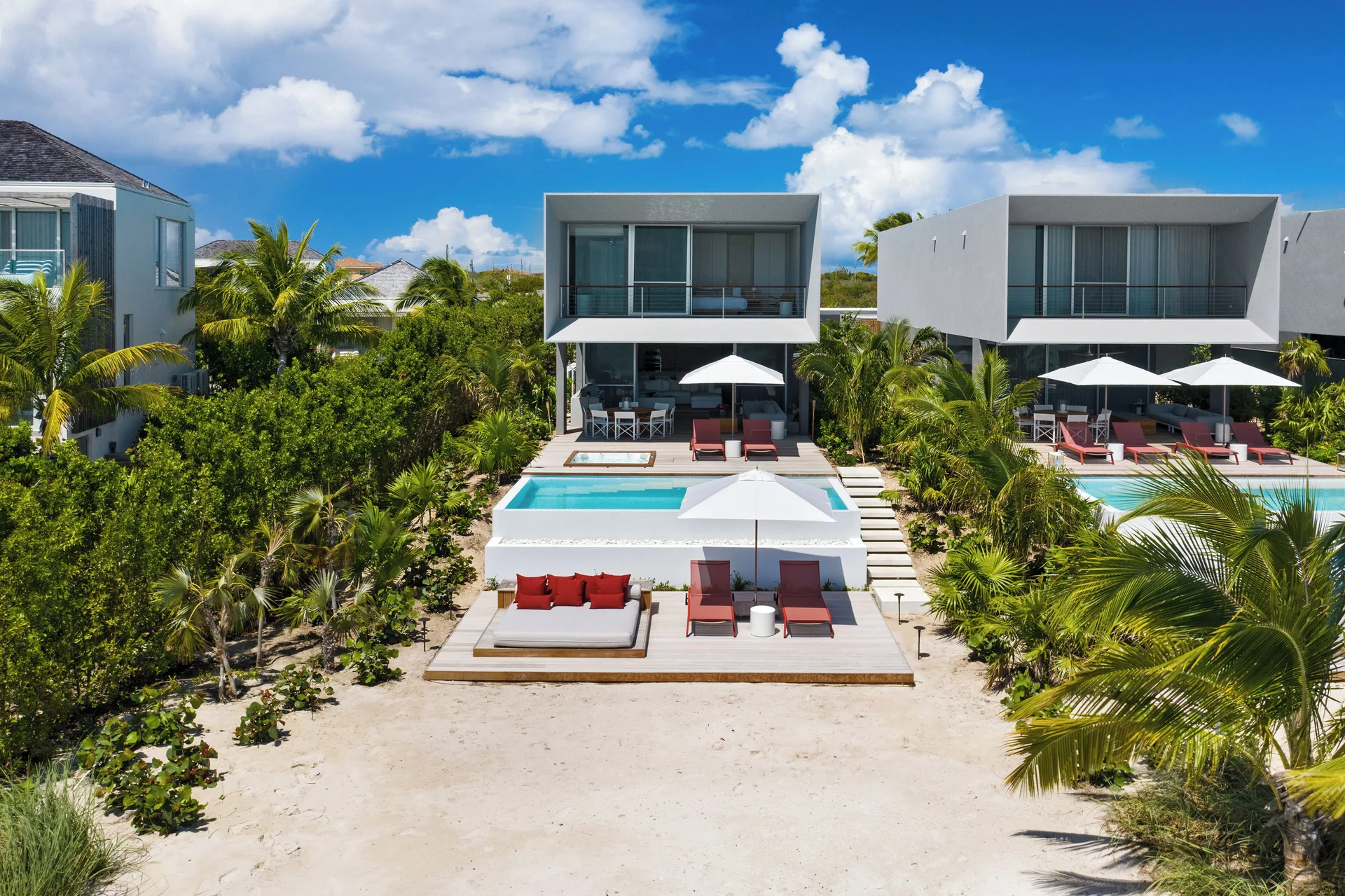 Beachfront beach houses with private pools and loungers at Beach Enclave.