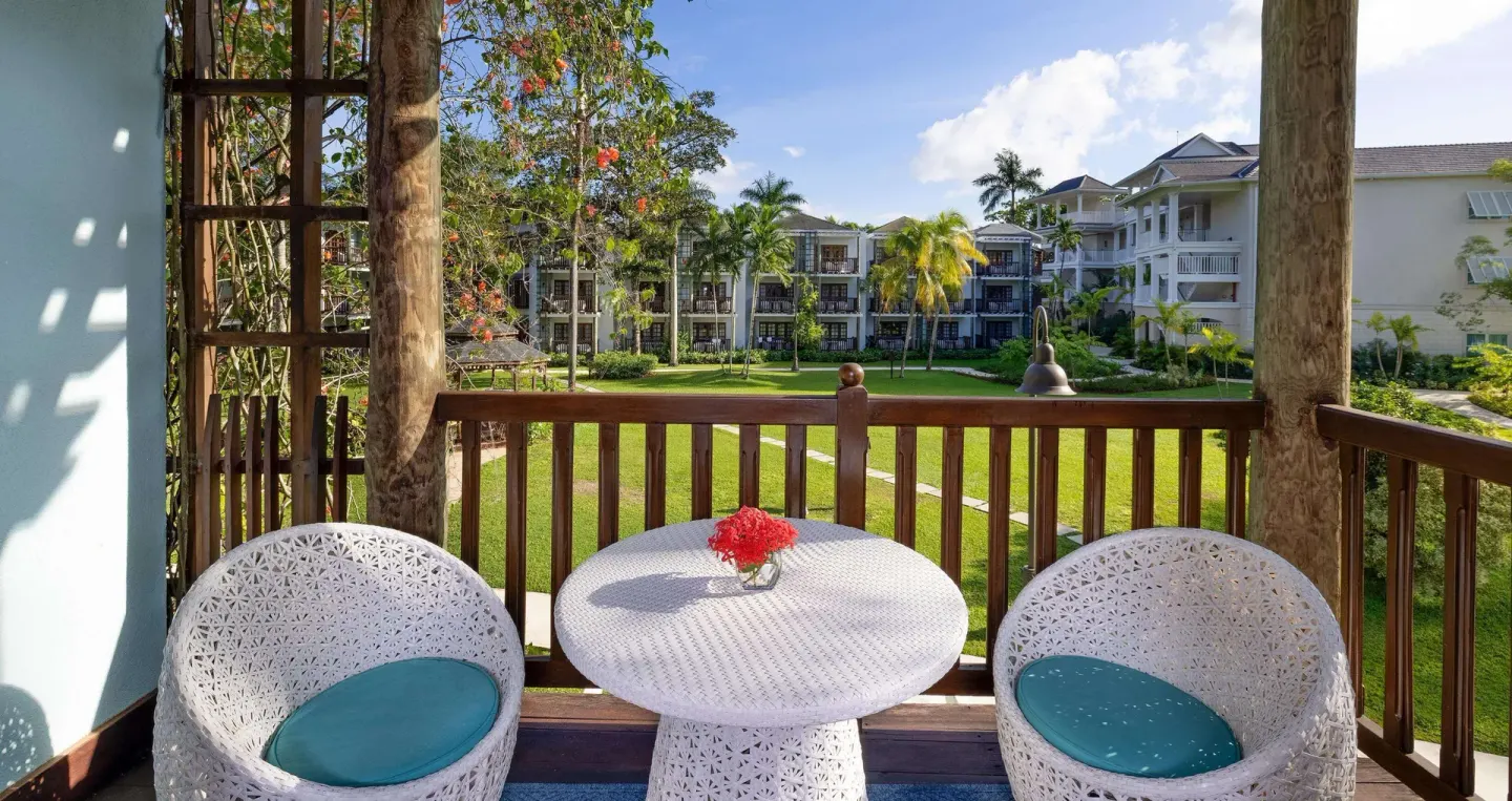 Balcony seating overlooking lawns and resort buildings at Beaches Negril Resort.