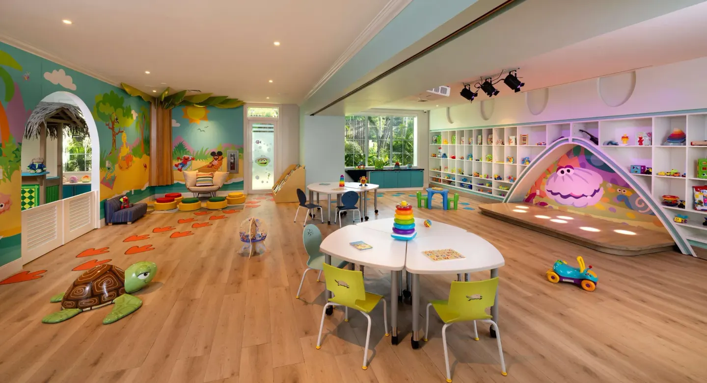 A colorful children's playroom with toys and activity tables at Beaches Negril Resort.