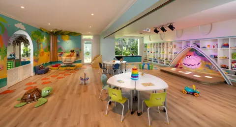 A colorful children's playroom with toys and activity tables at Beaches Negril Resort.