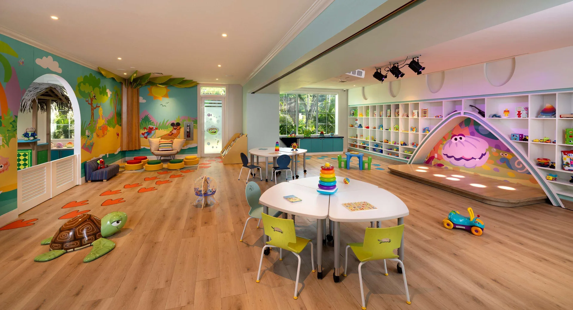 A colorful children's playroom with toys and activity tables at Beaches Negril Resort.