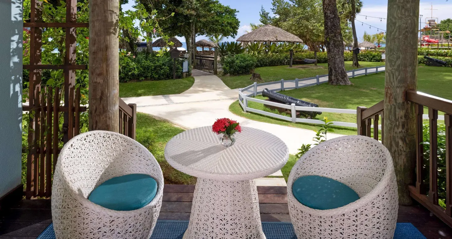 Patio seating overlooking paths and gardens at Beaches Negril Resort.