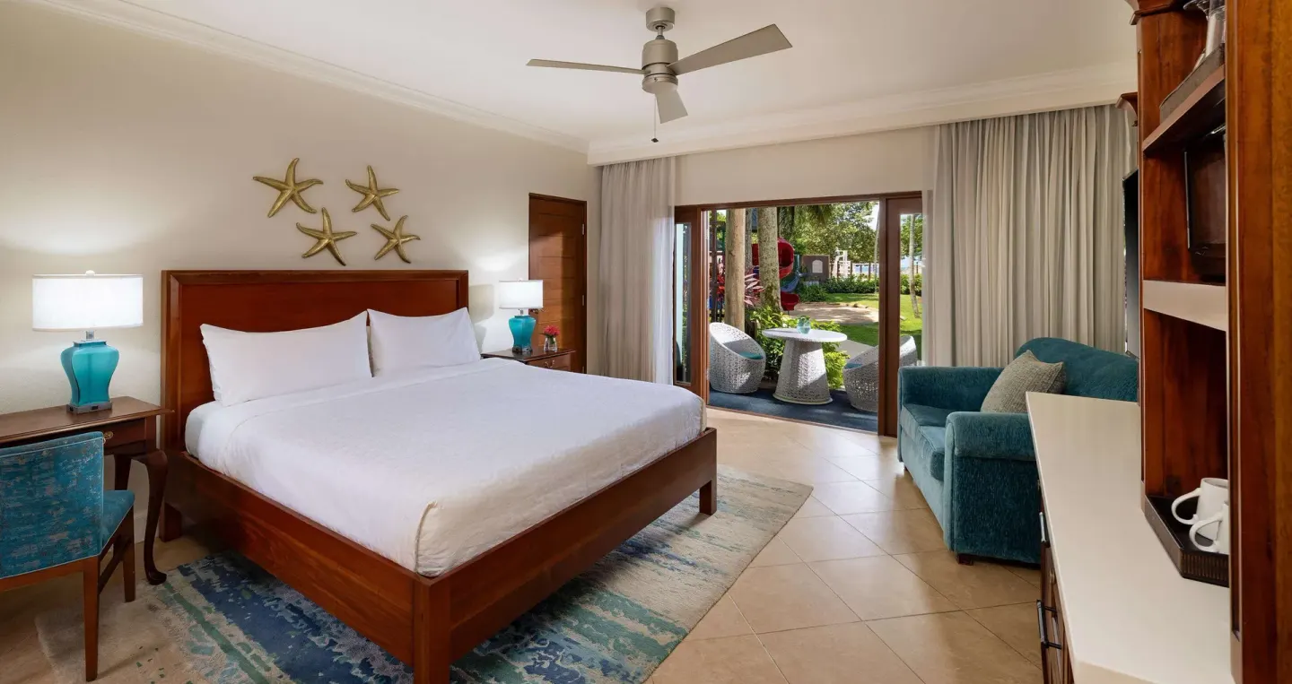 King bed guest room with patio seating at Beaches Negril Resort.