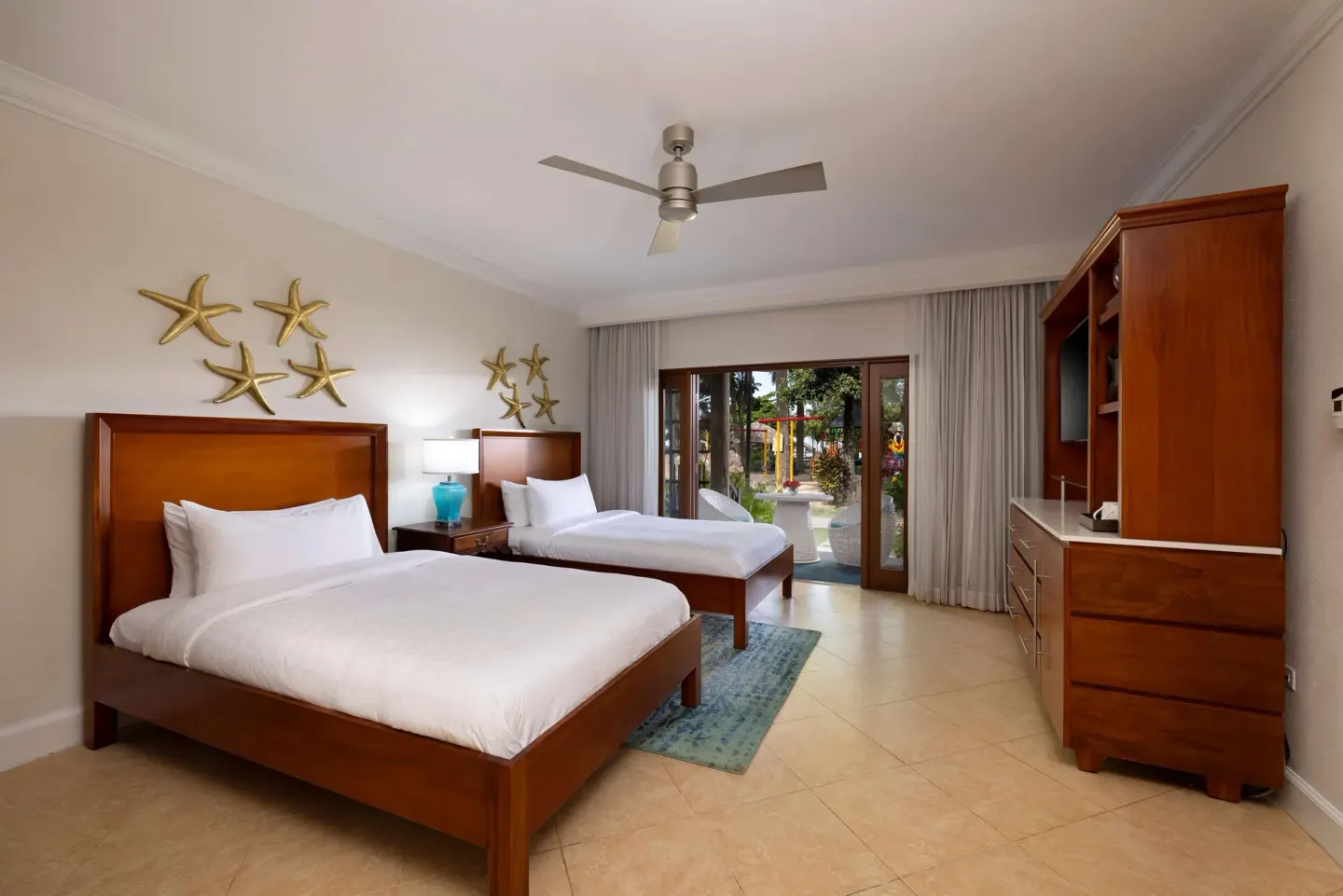 Two-bed guest room with garden patio at Beaches Negril Resort.