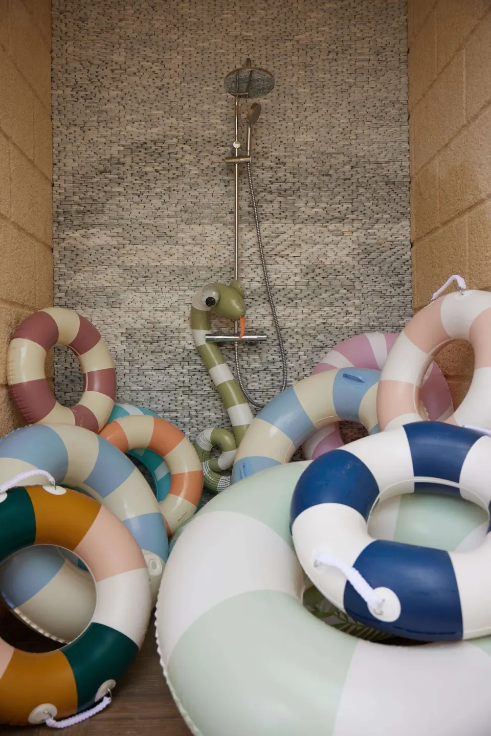 Colorful pool floats fill an outdoor shower area at Beaches Negril Resort.