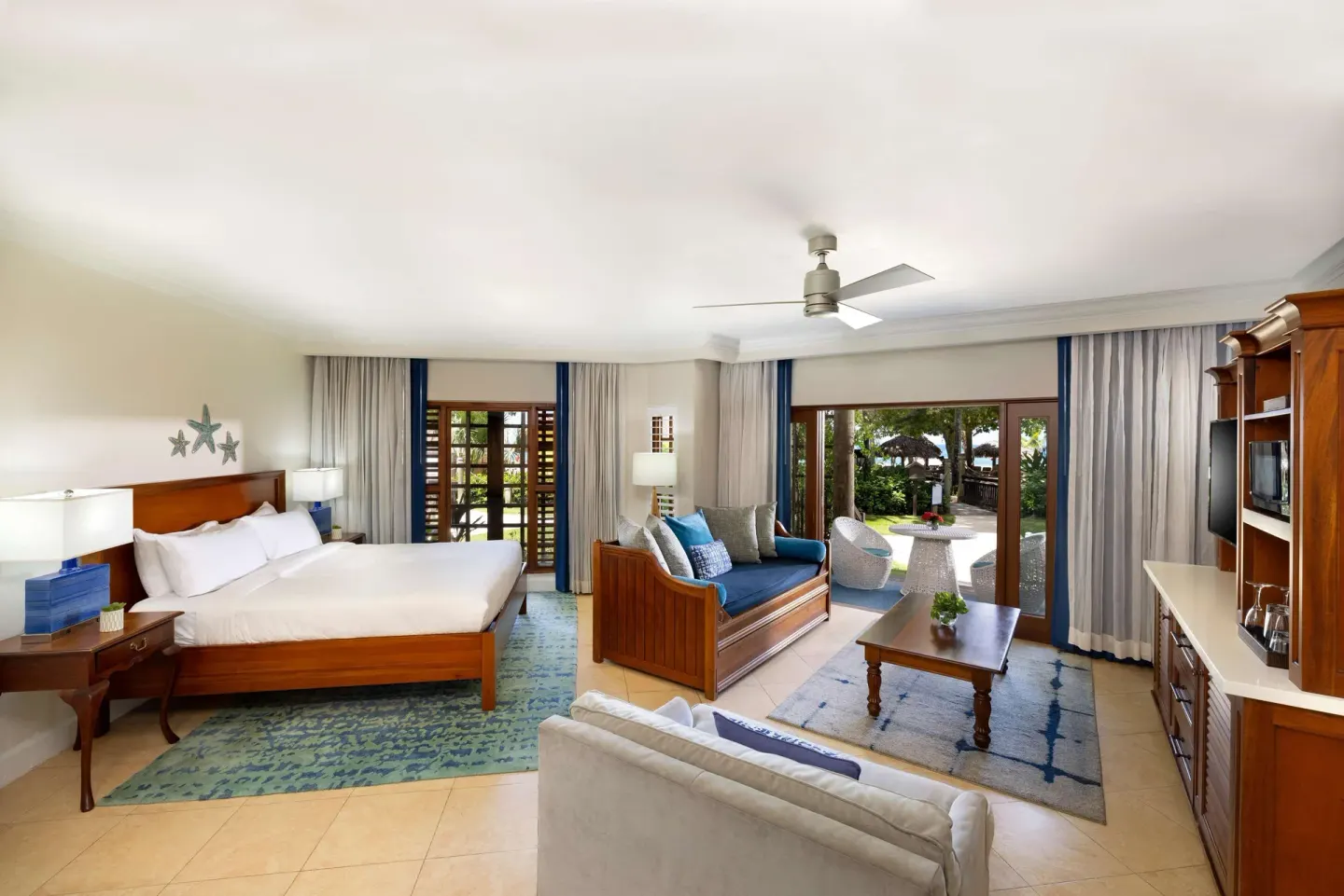 Spacious king bed suite with sitting area and patio at Beaches Negril Resort.