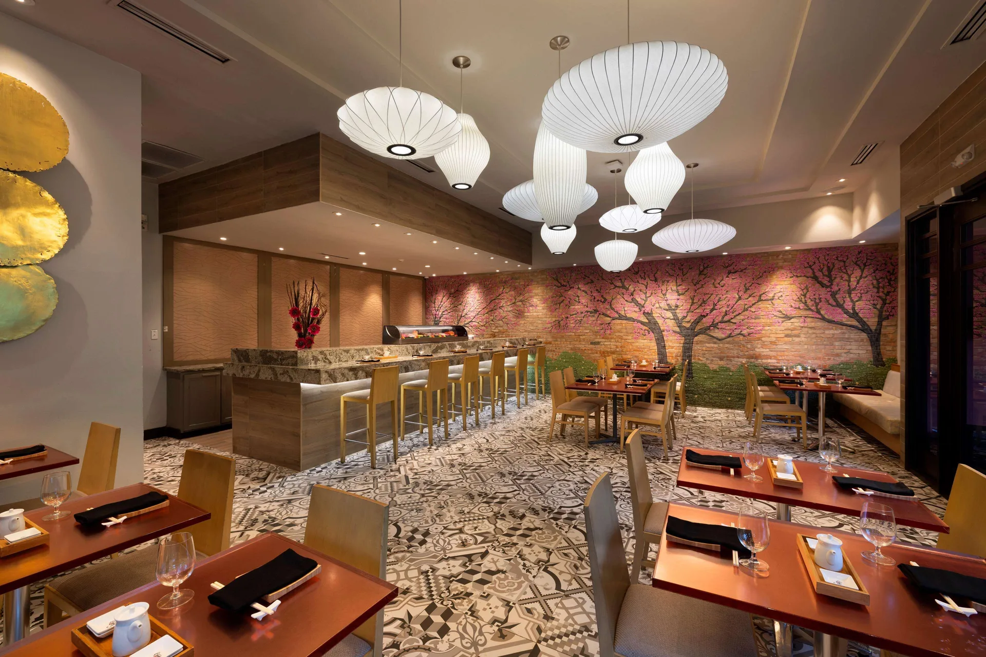 Sushi restaurant with bar seating, lantern lights, and tree mural at Beaches Negril Resort.