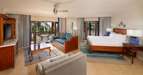 King bed and sitting area in a Concierge Tropical Oceanview Junior Suite at Beaches Negril Resort.
