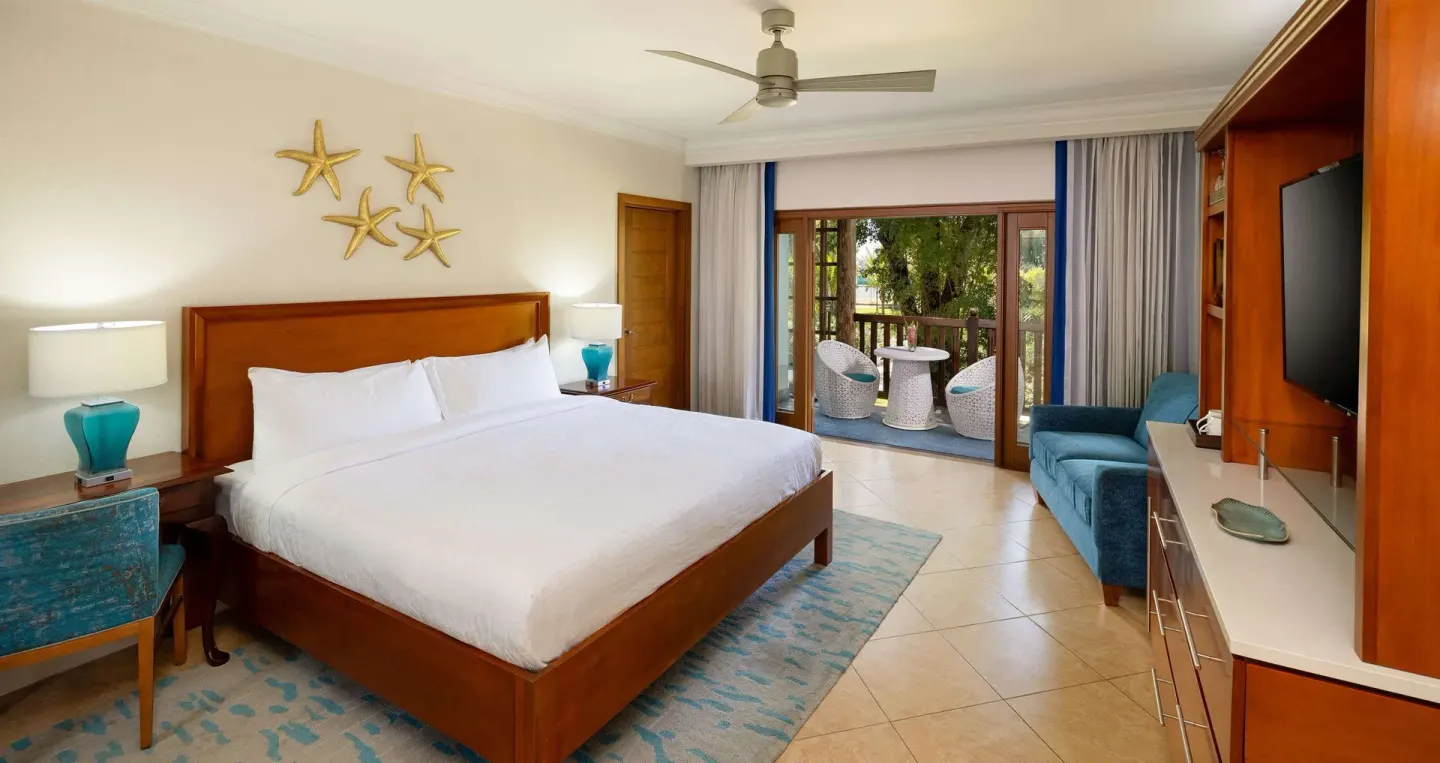 King bedroom with balcony seating in a family room at Beaches Negril Resort.
