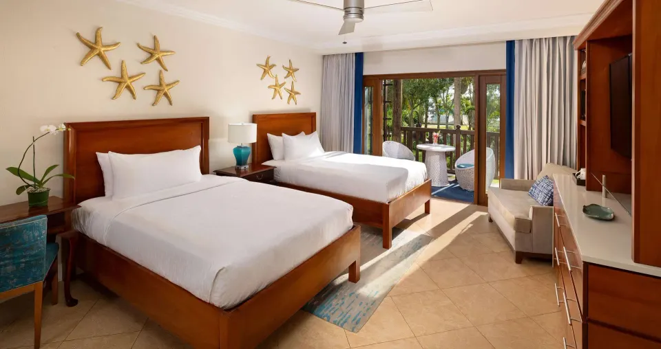 Two-bed family room with balcony and sitting area at Beaches Negril Resort.