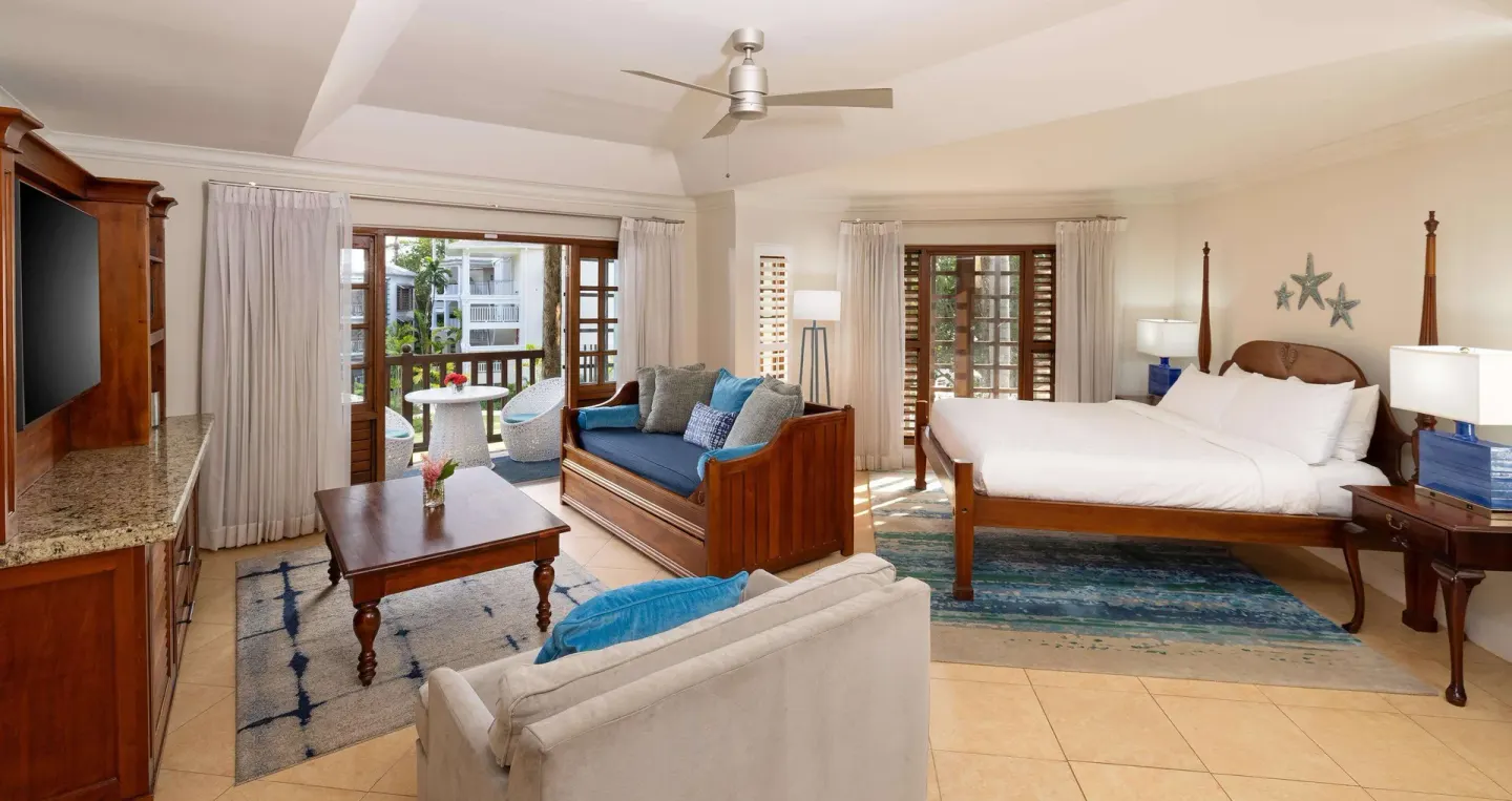 Tropical Oversized Concierge Suite with king bed and sitting area at Beaches Negril Resort.