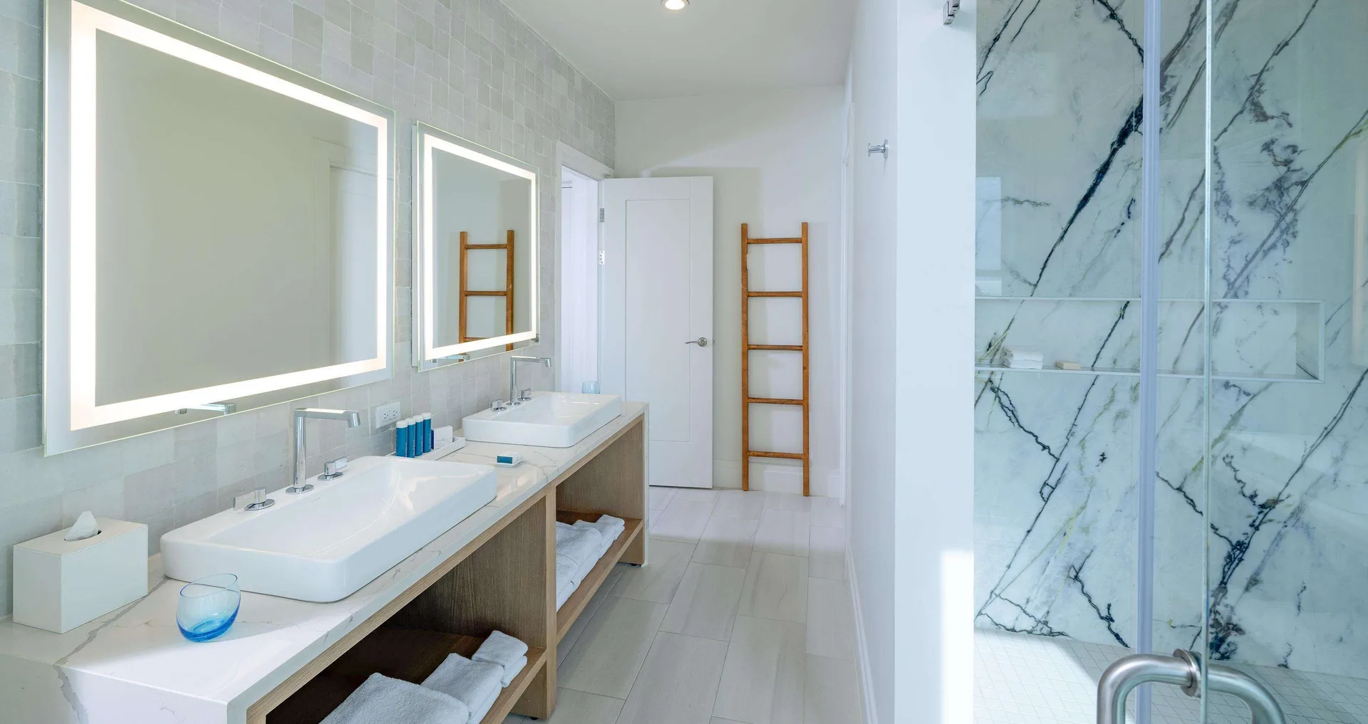Bright bathroom vanity and glass shower in the Firesky Reserve Villa suite at Beaches Negril Resort.