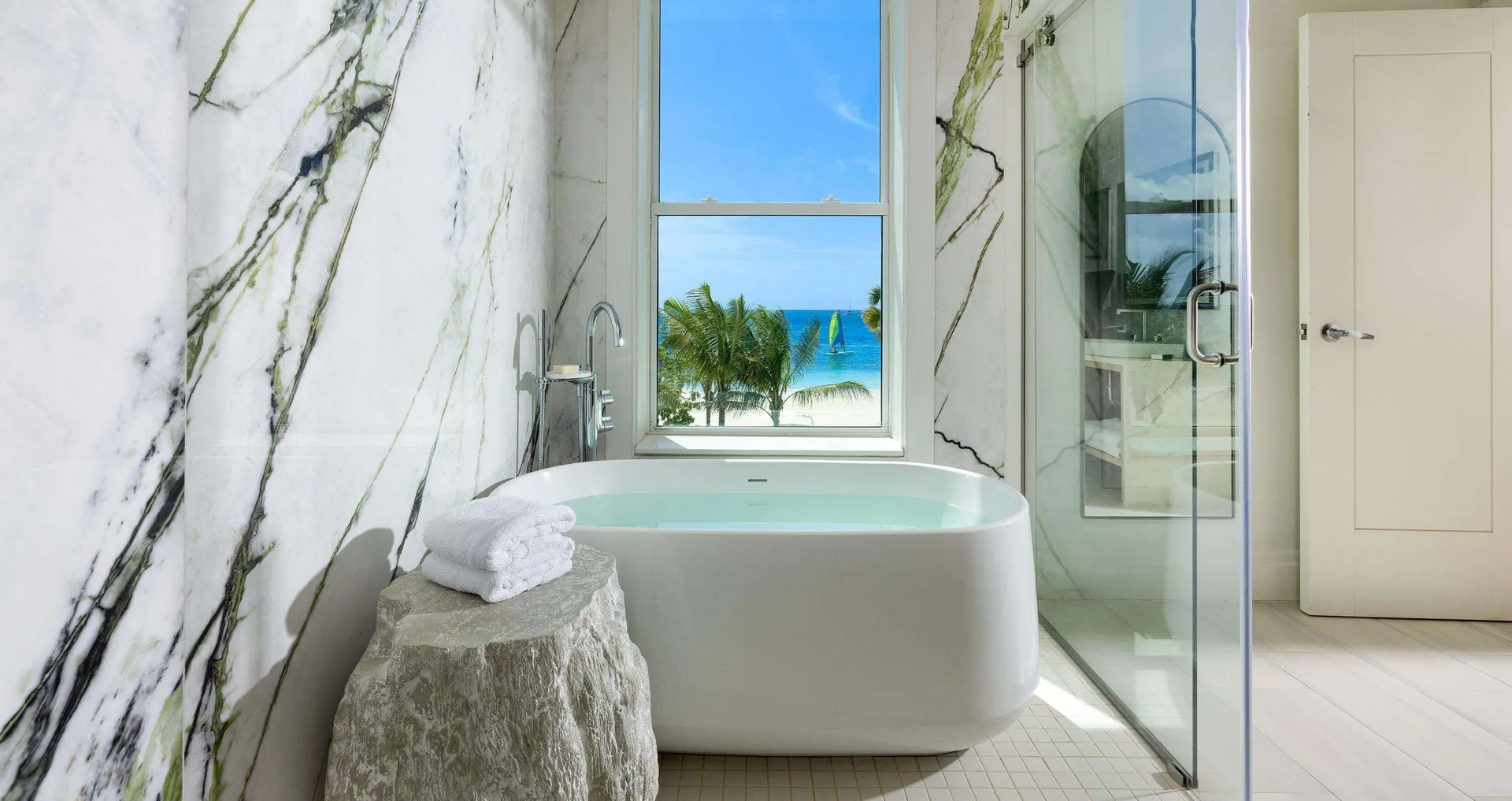 Bathroom soaking tub with ocean view in Firesky Reserve Villa at Beaches Negril Resort.
