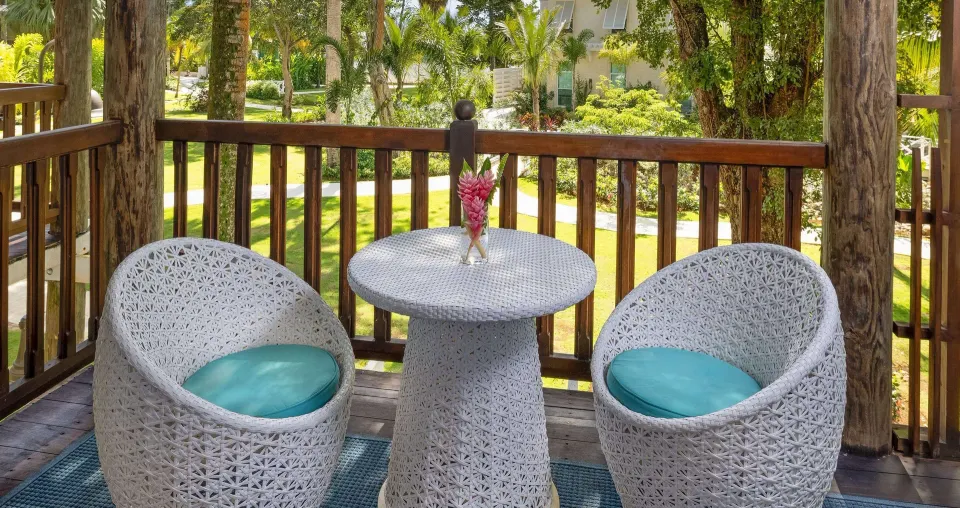 Furnished balcony of a Grand Suite at Beaches Negril Resort overlooking tropical gardens.