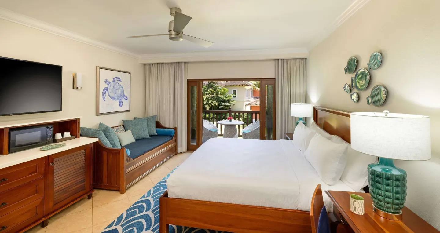 Luxury garden view room with king bed, daybed, and balcony at Beaches Negril Resort.
