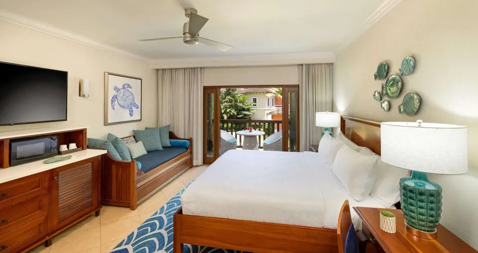Luxury garden view room with king bed, daybed, and balcony at Beaches Negril Resort.