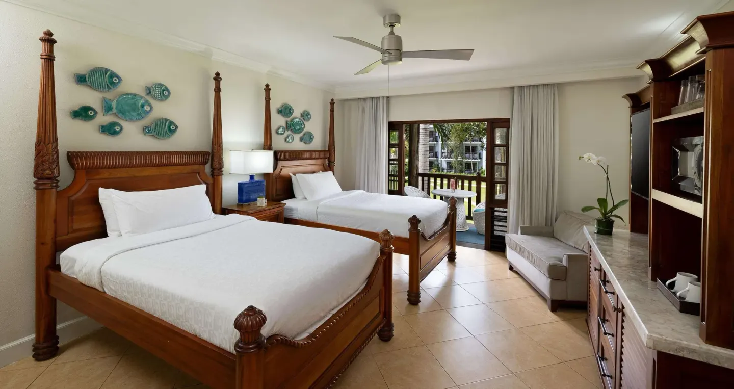 Tropical Concierge room with two poster beds and balcony at Beaches Negril Resort.