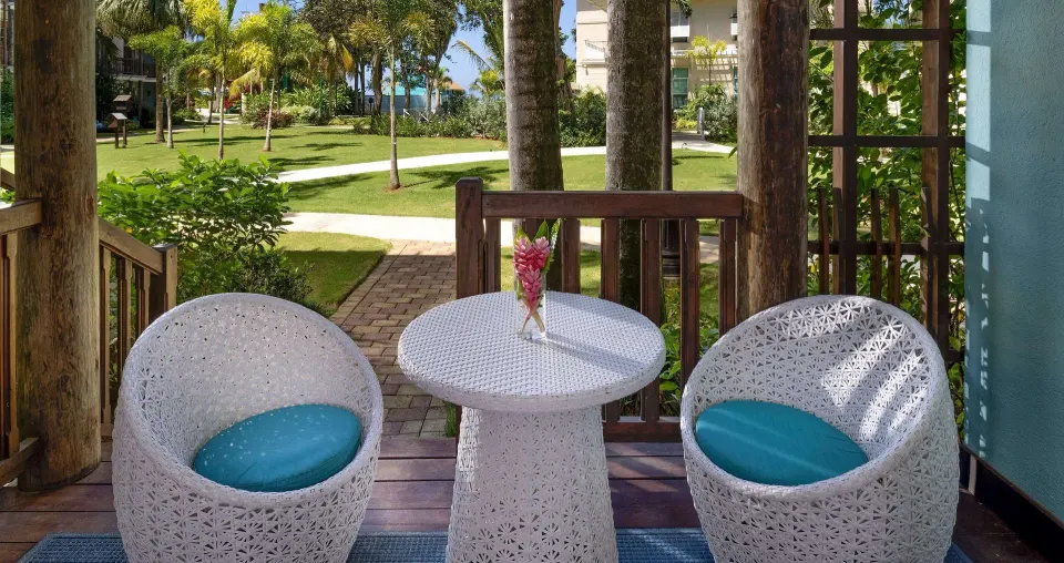 Tropical Oversized Concierge Suite patio seating and garden view at Beaches Negril Resort.