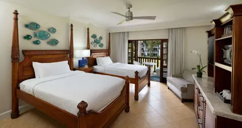 Tropical Oversized Concierge Suite with two poster beds at Beaches Negril Resort.