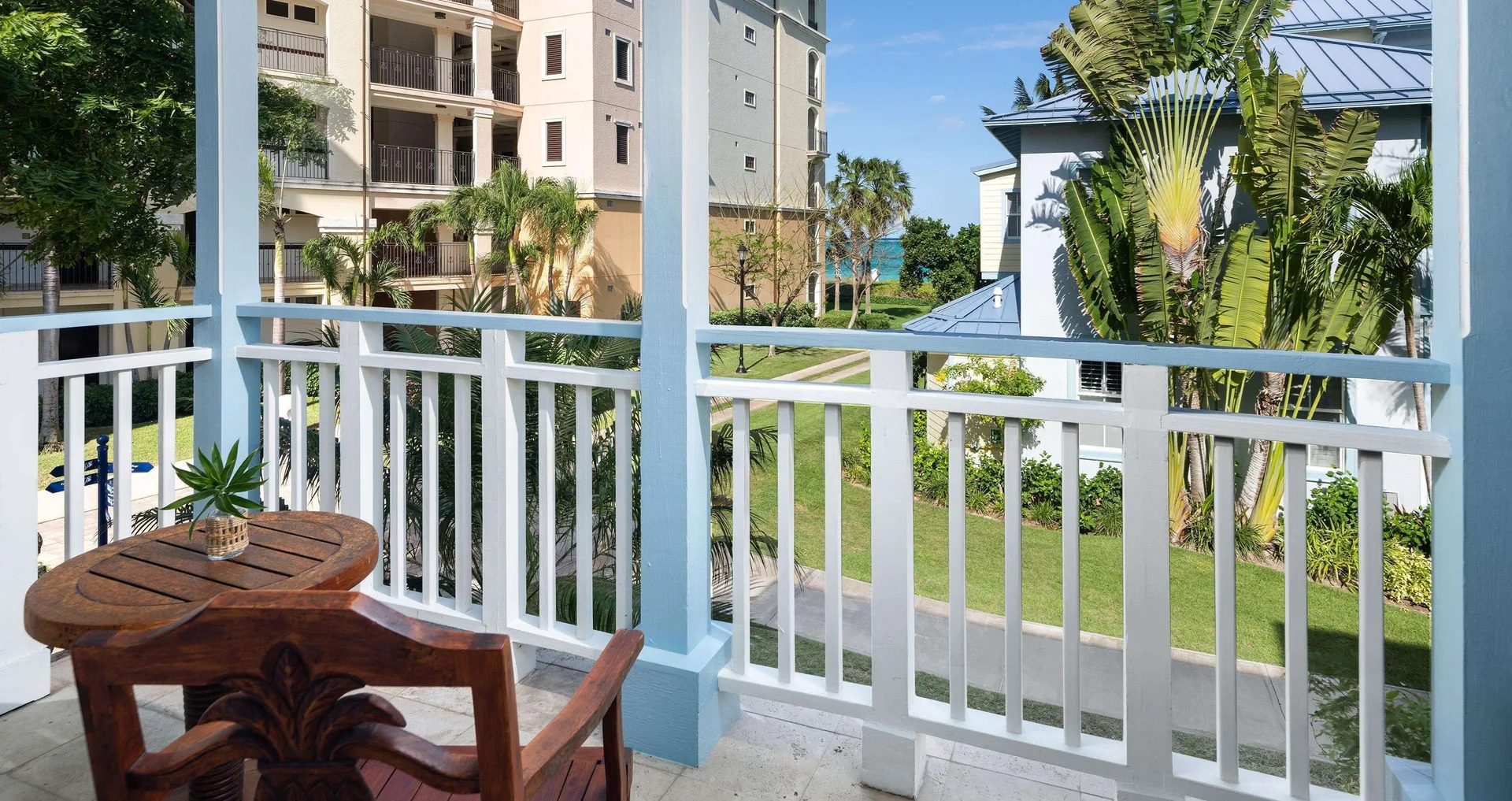 Balcony table overlooking resort gardens and ocean at Beaches Turks & Caicos.