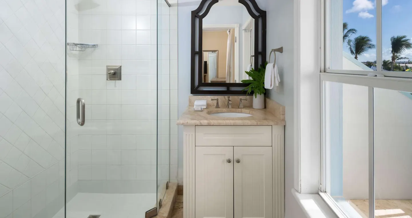 Bathroom vanity and glass shower with window view at Beaches Turks & Caicos.