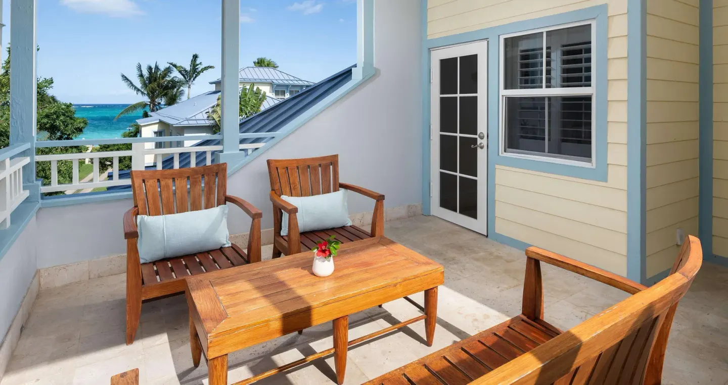 Covered balcony with wood seating and ocean view at Beaches Turks & Caicos.
