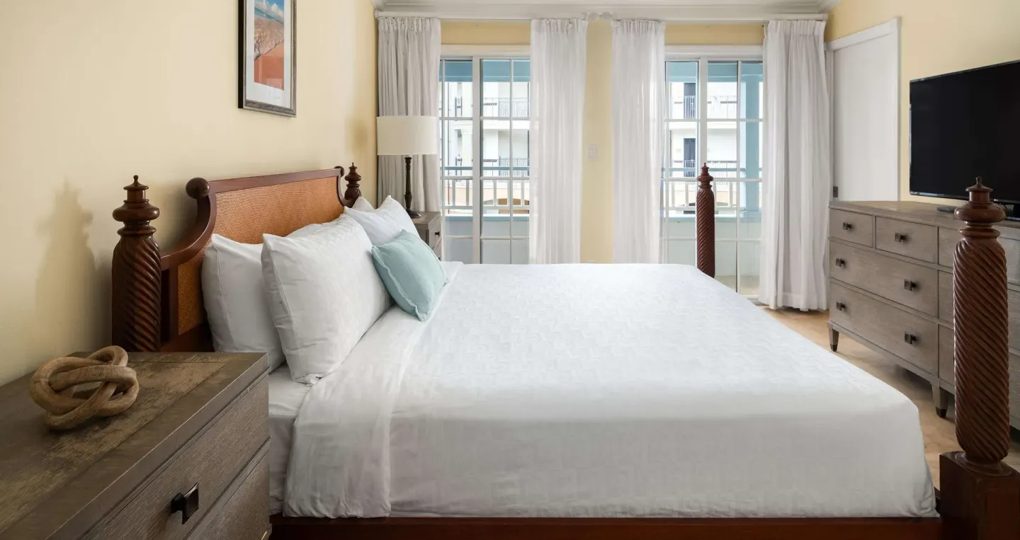 Four-poster king bedroom with balcony doors at Beaches Turks & Caicos.