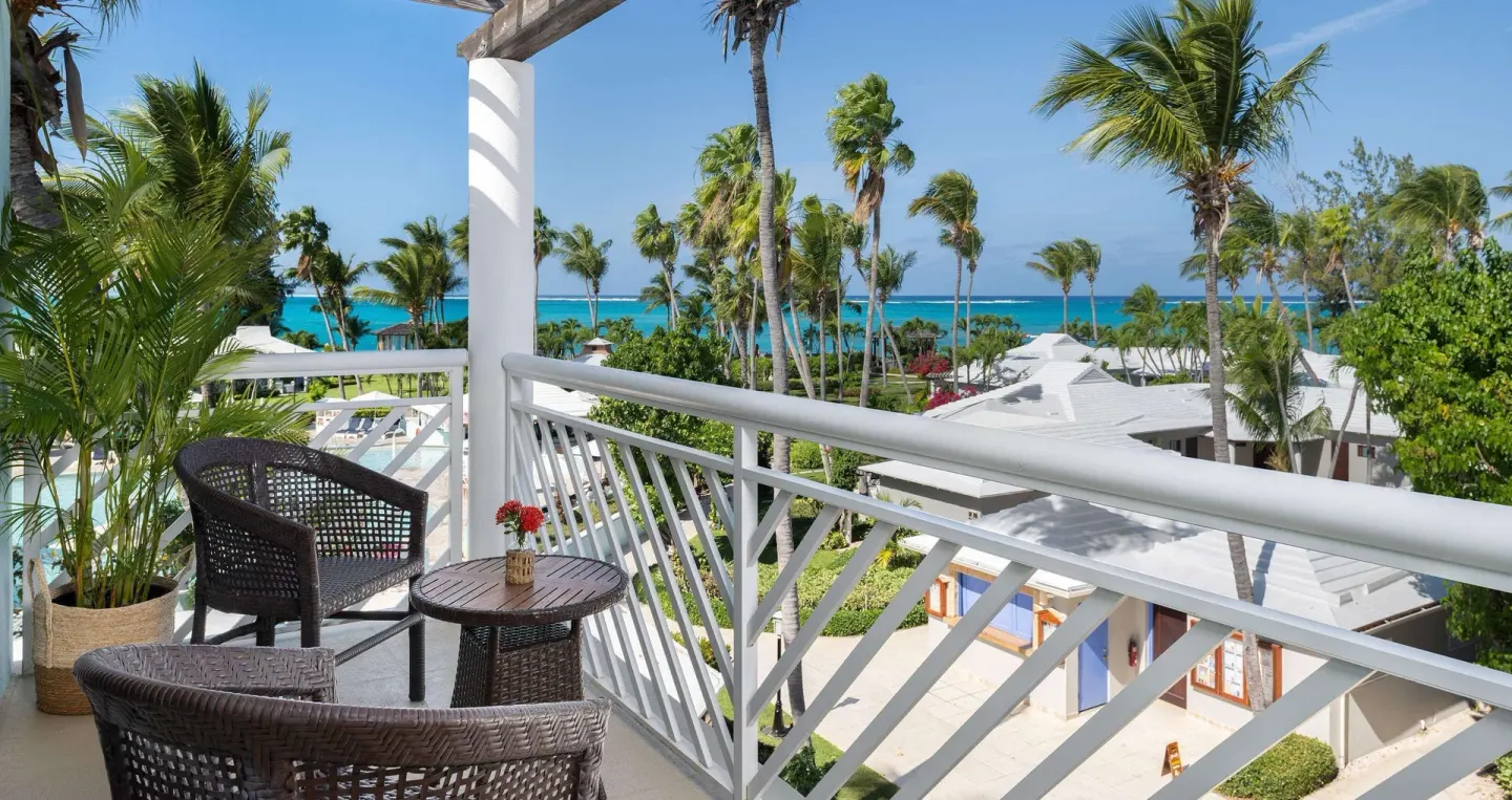 Furnished balcony with palm and ocean views at Beaches Turks & Caicos.