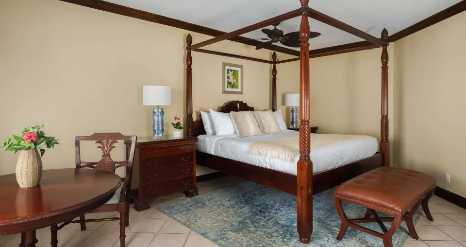 Guest room with a four-poster king bed at Beaches Turks & Caicos.