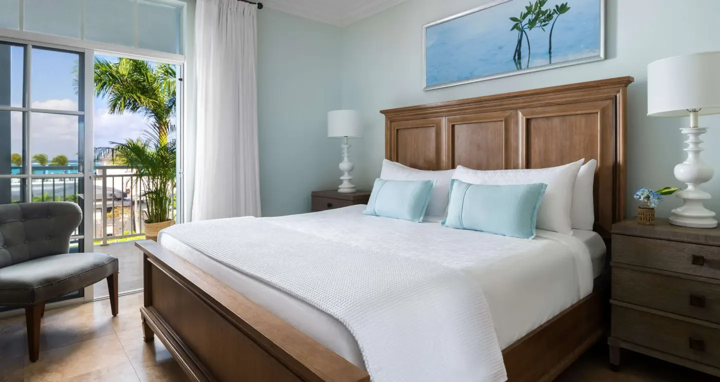 King bed beside balcony doors in a guest room at Beaches Turks & Caicos.