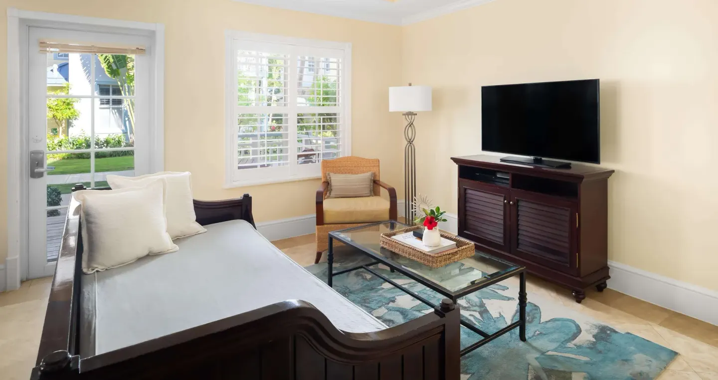 Guest room sitting area with daybed and television at Beaches Turks & Caicos.