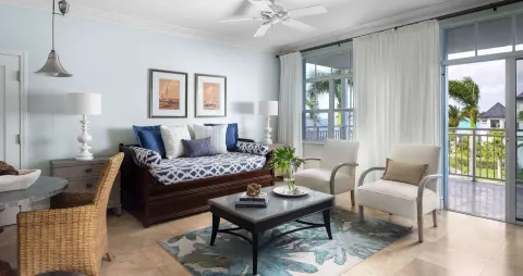 Living area with daybed and balcony doors at Beaches Turks & Caicos.