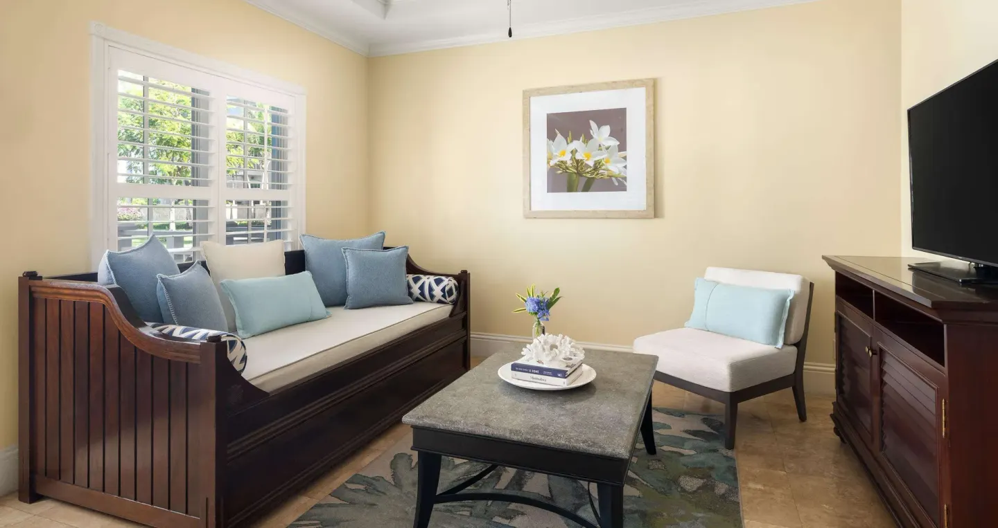 Sitting room with daybed, chair, coffee table, and TV at Beaches Turks & Caicos.