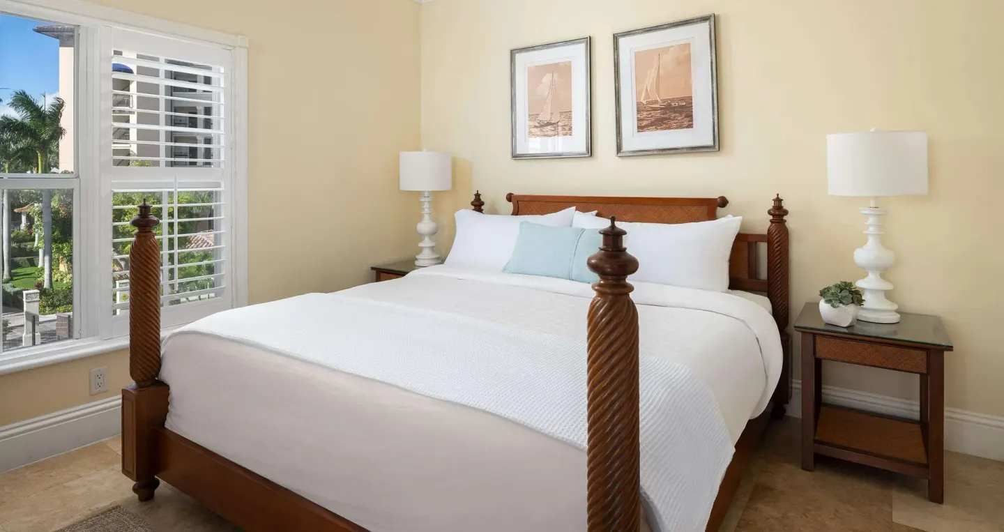 King bedroom with plantation shutters and garden view at Beaches Turks & Caicos.