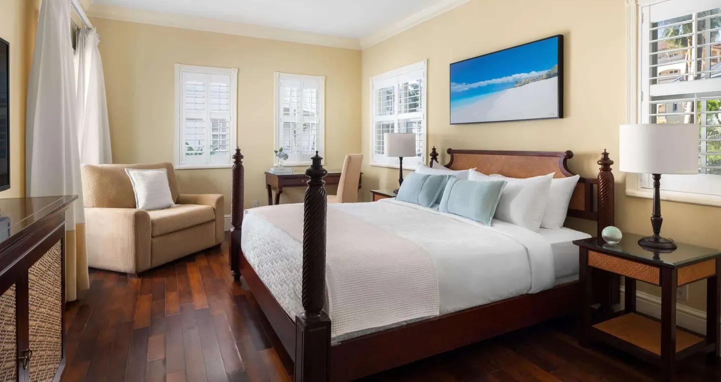 King bedroom with sitting chair and beach artwork at Beaches Turks & Caicos.