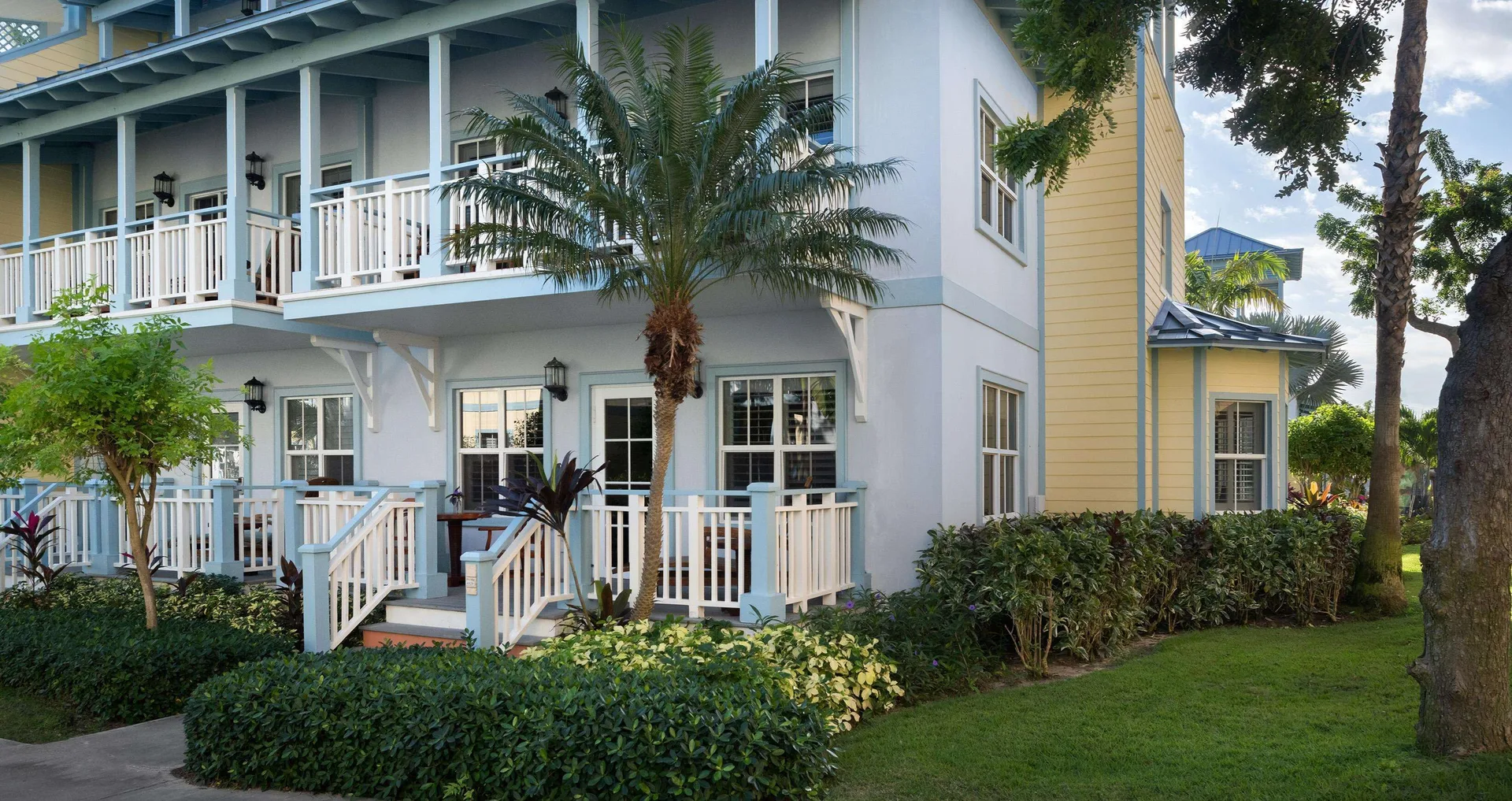 Pastel guest building with porches and gardens at Beaches Turks & Caicos.