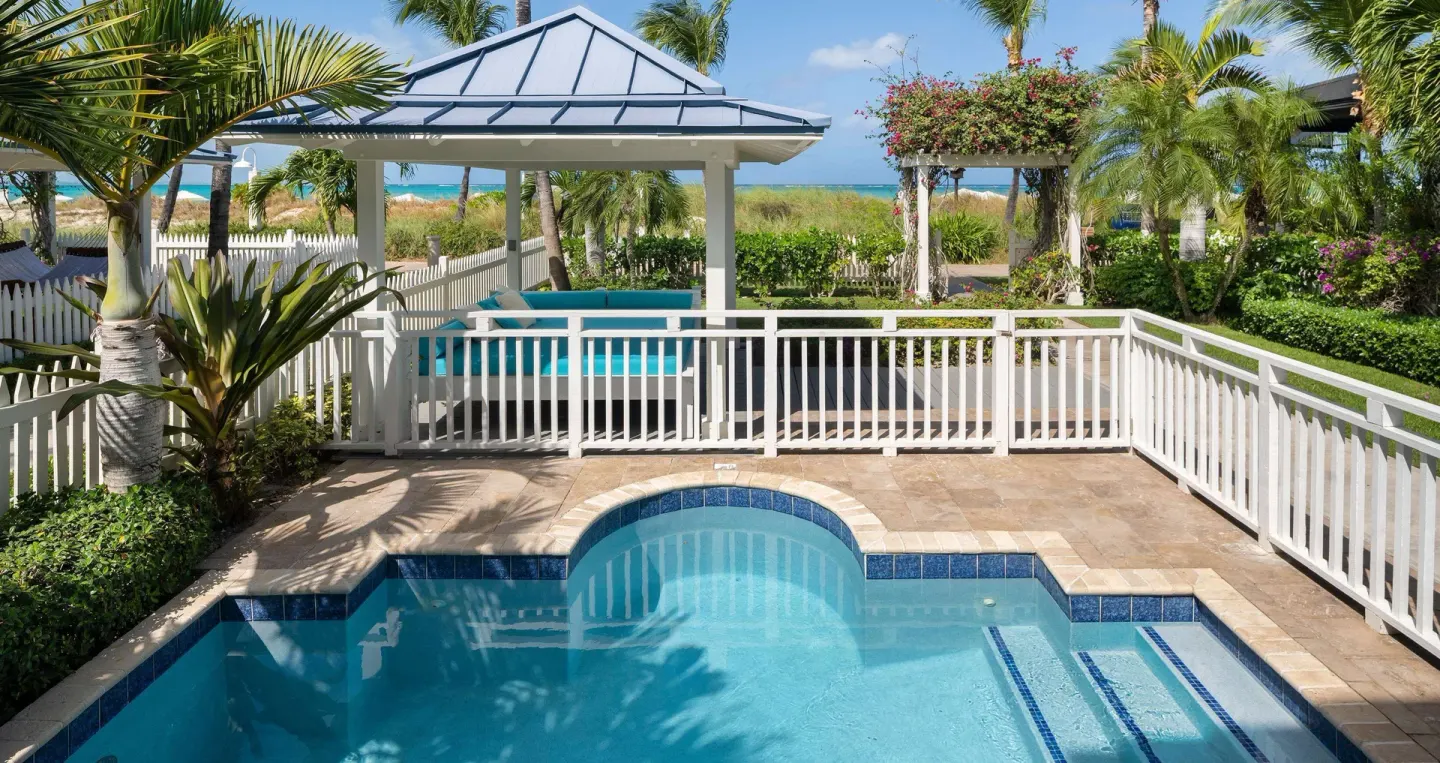 Private pool terrace with white fencing near the beach at Beaches Turks & Caicos.