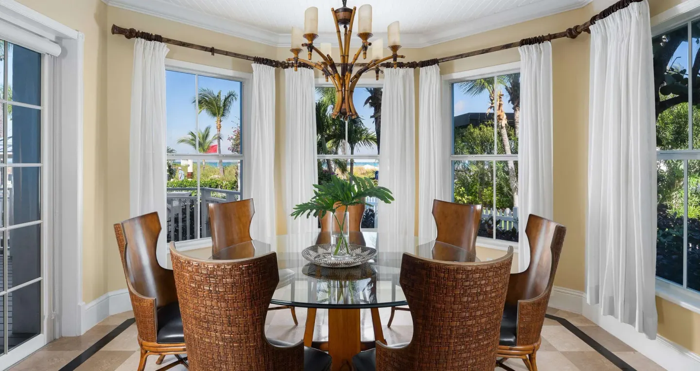 Round glass dining table by ocean-facing windows at Beaches Turks & Caicos.