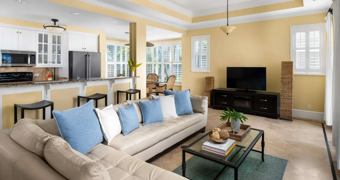 Spacious suite living room with kitchen and TV at Beaches Turks & Caicos.